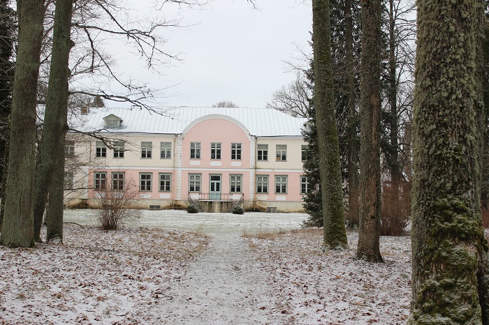 a winter time  view to pink baroque style Luua manorhouse from back, some old trees allso visible 