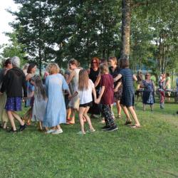 Naised ja lapsed tantsivad ringis Ähijärve ääres